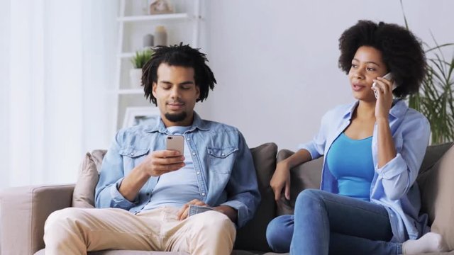 happy couple with smartphones at home