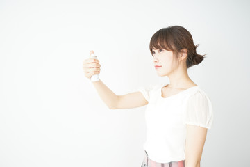 Young woman washing her face with water