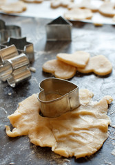 Close up of cookie cutters in a dough