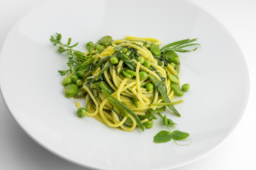 Pasta dish spaghetti with herbs and spring veggies