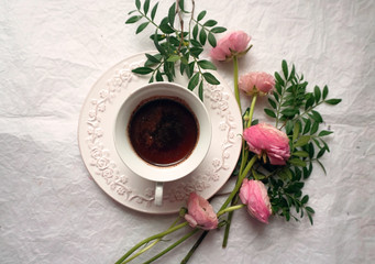 Obraz na płótnie Canvas Vintage cup of coffee and a flowers