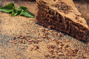 chocolate cake with Candies and cup of coffee,Chocolate cake with a cut piece and blade on gray background, closeup,Dark chocolate cake,Delicious vegan chocolate cake,Tasty chocolate cake 