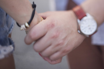 Men & woman holding hands. Close-up