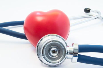 Stethoscope examines heart shape in front and twists around. Concept picture for process diagnostics, treatment and prevention of heart disease such as myocardial infarction, arrhythmia, heart failure