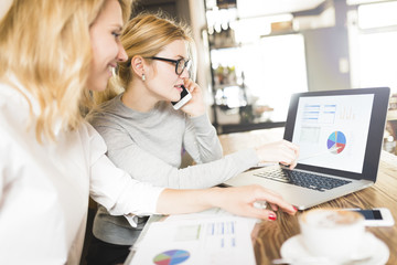 Two businesswomen working together on project
