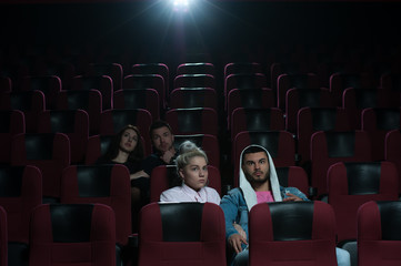 Two happy romantic couples in movie theater