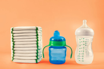 Stack of diapers. Baby bottles
