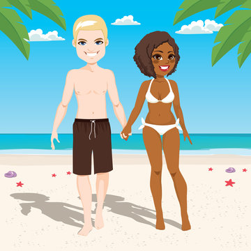 Happy young interracial couple at beach on vacation