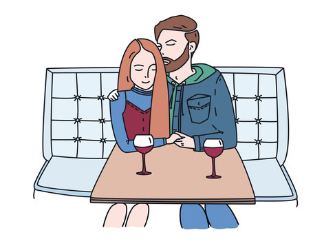 Young couple sits in a cafe and drinks wine