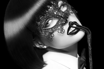 Sexy woman in mask, whip on red lips, bdsm, isolated. Black and white