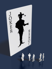 Business figures looking up at the Joker card