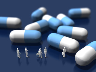 Business figures looking at tablet capsules