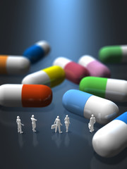 Business figures looking at colorful tablet capsules