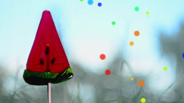 Red Lollipop in the shape of watermelon slices.Rotation and cartoon effect. Loop