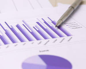 Financial accounting and marketing graphs analysis with a silver pen
