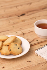 butter cookies with tea on wooden background.