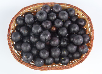 Jaboticaba in a bamboo basket isolated on white background
