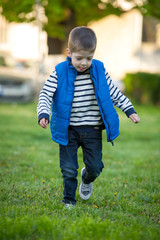 little boy running on grass