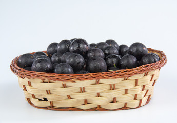 Jaboticaba in a bamboo basket isolated on white background
