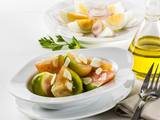 Tomato and egg salad with garlic and raw onions.Tomato and egg salad with garlic and raw onions.