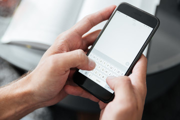 Cropped photo of young man chatting by phone.