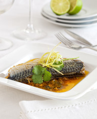 Pickled mackerel in a sauce on a plate