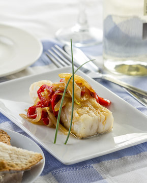 Delicious fried cod fillet with onions and bell pepper.