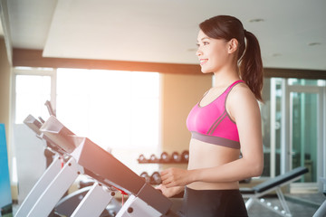 Fototapeta na wymiar woman stand on treadmill