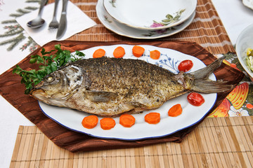 Fried carp on a plate
