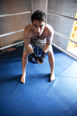 Fototapeta na wymiar Top view of man boxer sitting in the corner of ring