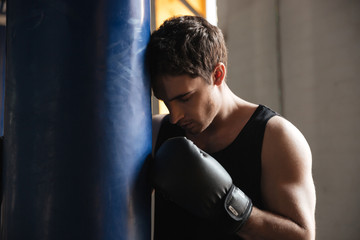 Fototapeta na wymiar Pensive sportsman boxer thinking about training