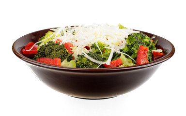 Salad with broccoli, red pepper and onion in a brown bowl
