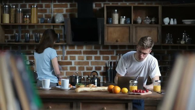 Attractive couple spending leisure in the kitchen