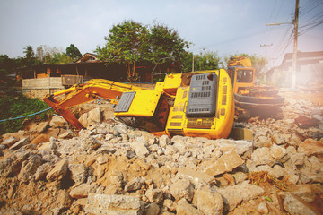 The backhoe is overturning at the construction site