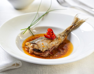 Fried Atlantic horse mackerel in a spicy sauce