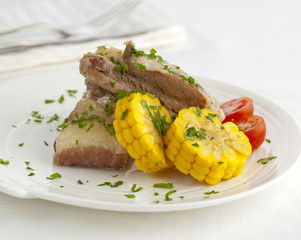 Gourmet pork ribs served with parsley and corn