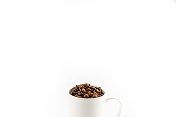 roasted coffee beans in coffee mug  isolated on white © LIGHTFIELD STUDIOS