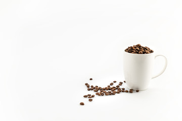 roasted coffee beans in coffee mug  isolated on white