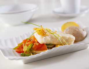 Grouper fillet served with fried garlic an vegetables.Grouper fillet served with fried garlic an vegetables.