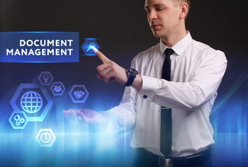 Business, Technology, Internet and network concept. Young businessman working on a virtual screen of the future and sees the inscription: Document management