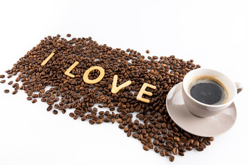 Naklejka premium cup of coffee and coffee beans with cookies in shape of Love word isolated on white