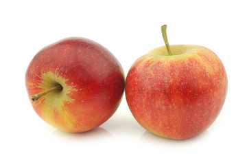 two fresh red and yellow apples on a white background