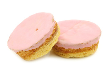 Traditional Dutch pink glazed cakes on a white background