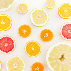 Fruit background. Sliced citrus fruits on white background. Flat lay, top view.