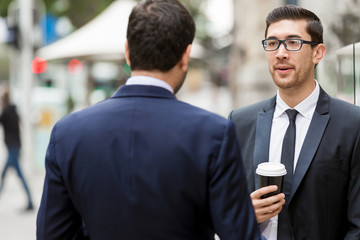 Two businessmen talking outdoors