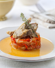Goat cutlets on a bed of fried onion and bell pepper.