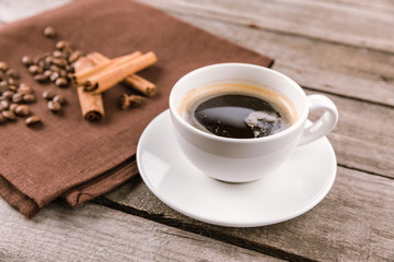 close up view of coffee mug steam and cinnamon sticks