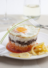 Rice with tomato sauce and fried egg called arroz a la cubana.