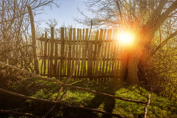 Sun rays through wooden gate on a mountain house traditional landscape village countryside 