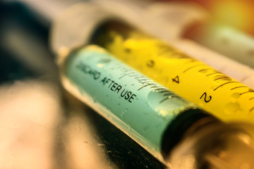Colorful syringes with research liquid cancer gene DNA research, cancer early detection